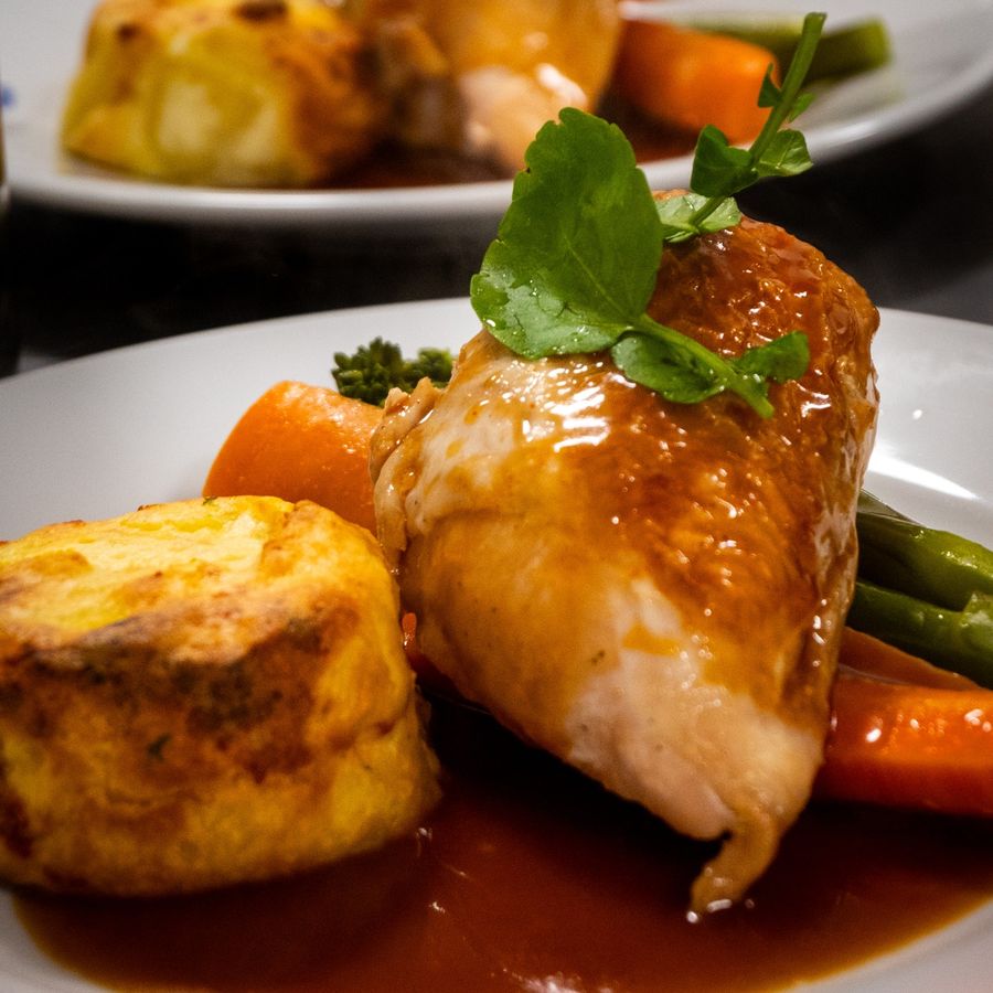 Roast chicken breast with potato gratin, carrots and green beans in gravy